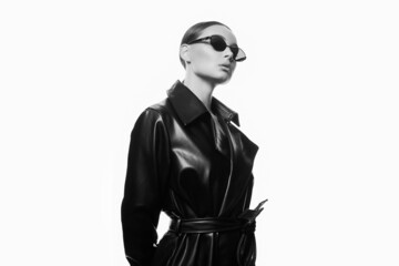 fashion black and white portrait of Beautiful woman in sunglasses and leather trench coat