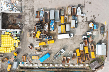 A lot of containers for collecting city garbage, sorting and processing garbage, a garbage truck for transporting and collecting garbage. View from above