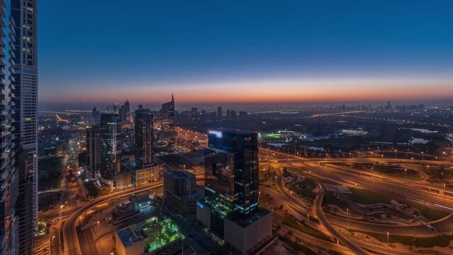 Aerial view of media city and al barsha heights district area night to day timelapse from Dubai marina.