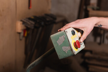 partial view of carpenter pushing button on control relay.