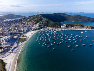 Charming paradise beach with fishing and tourism boats in a beautiful village, Praia dos Anjos, Arraial do Cabo, Rio de Janeiro