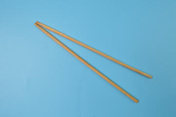 Wooden chopsticks isolated on a blue background