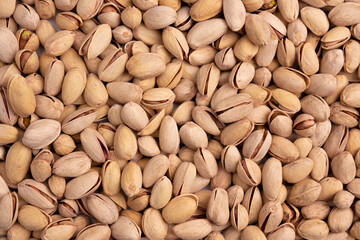background of unpeeled almond nuts, close up