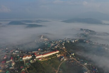 aerial view of the fog town with tranquility scene and beautiful and magical the fog at dawn