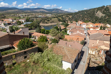 Fototapeta na wymiar Buitrago del Lozoya, Spain. Views of the Old Town and Lozoya river from the viewpoint of the belfry of the church of Santa Maria del Castillo