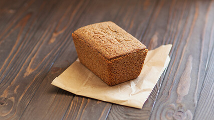 Bread, traditional sourdough bread on a rustic wooden background. The concept of traditional ways of baking yeast bread. Healthy food.