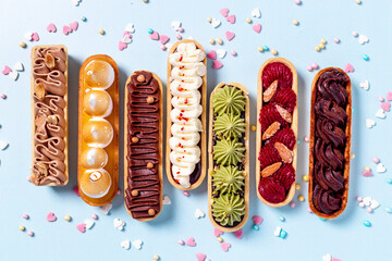 Cupcakes eclairs with pistachio raspberries and chocolate cream topping