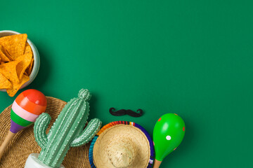 Cinco de Mayo holiday background with Mexican cactus, nachos chips, maracas and party sombrero hat....