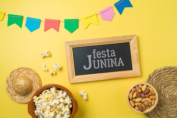 Festa Junina party background with popcorn, peanuts and chalkboard. Brazilian summer harvest festival concept. Top view, flat lay