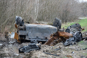 Fototapeta premium An infantry fighting vehicle overturned on the side of the road.