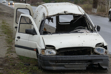 Obraz na płótnie Canvas Damaged civilian car in the war in Ukraine. Shot car.