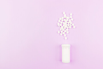 White pills on a pastel pink background. Flat lay, top view, overhead, mockup, template, copy space. Pharmacy and medical concept