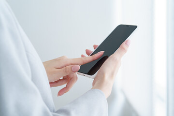 Woman holding a smartphone indoors