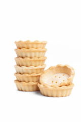 Stack of empty tartlets (tarts, tart shells) isolated on the white background