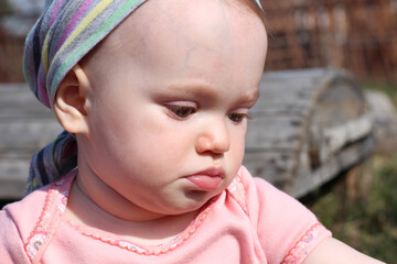 portrait of a cute baby in nature. sunny photo.