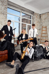 Young international musicians, a band performing on the loft stage. The concept of music, hobby, festival. Inspiration creativity.