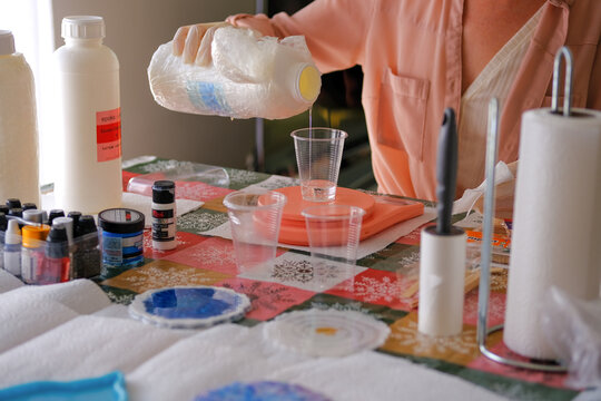 Woman making epoxy resin arts and crafts.
