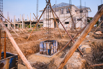 Construction of reinforced concrete foundation with piles to support building weight - 499628846