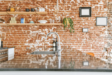 Bright kitchen with a brick countertop and brick wall