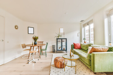 Interior of colorful living room with sofa and dining table