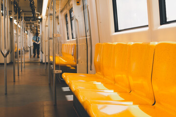 Empty seat inside subway or sky train with patrol walking through by security guards.