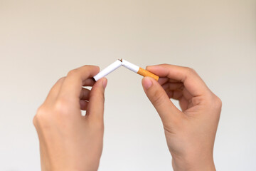 Woman hands holding and breaking the cigarette for quit smoking. Stop smoking for health concept.