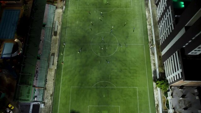 aerial view of a soccer field in full match