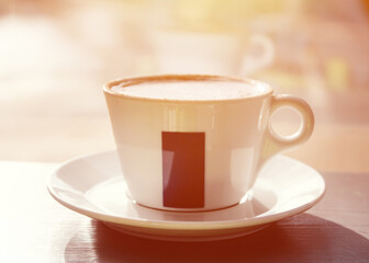 cup of coffee   on the table in cafe against window in sunny day