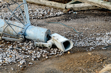 Broken CCTV camera laying on the ground. Concept of personal freedom and state surveillance
