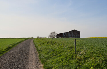 An old corrugated iron barn in the middle of the Wiltshire countryside on a public footpath surrounded by farmland
