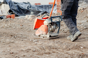 Light ground compactor used by groundworker on construction site