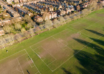 Aerial view of football field and houses in suburban south London area 