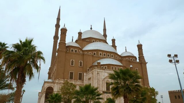 Great Mosque of Muhammad Ali Pasha or Alabaster surrounded trees. Religious landmarks, tourist attractions of Cairo. Islamic architecture of Egypt. Exterior, front view, facade of building