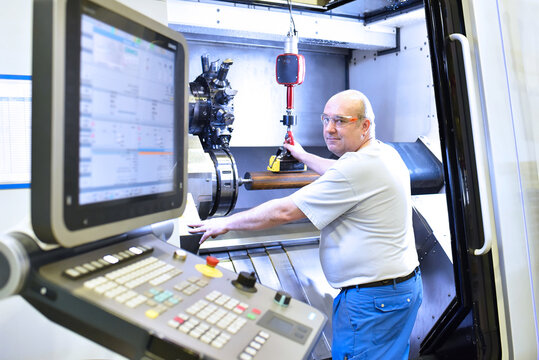 cnc machine in modern industrial mechanical engineering - workers at the workplace