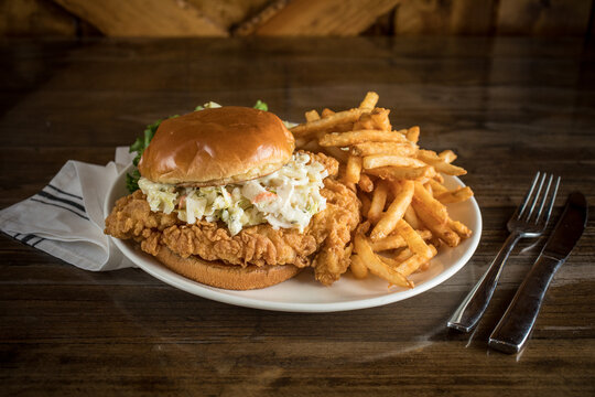 Enormous Buttermilk Chicken Fried Sandwich on a Wooden Table