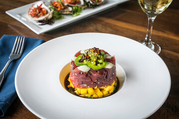 Ahi Tuna Tartare on a White Plate and Wooden Table 