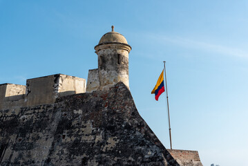 Colombian flag waving on the castle wall of the Spanish colonial era in the city of Cartagena in...