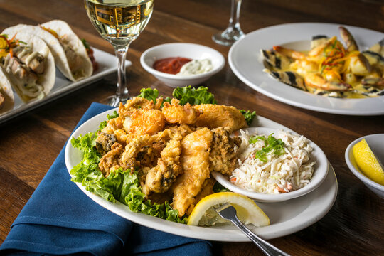 Fried Seafood Platter on a White Plate and Wooden Table