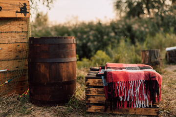 In the village in nature in the grass there is a wooden barrel and wooden boxes