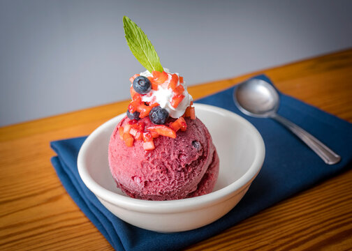 Fresh Berry Ice Cream in a White Bowl on a Blue Napkin
