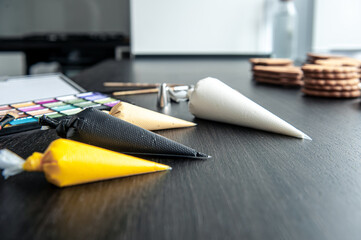 Pastry bags with cream for decorating gingerbread.