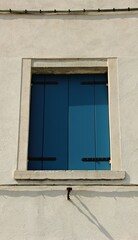 Italy, Veneto: Blue window of the white house.