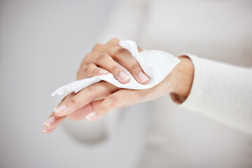 Wiping the germs away. Shot of an unrecognizable person using a wipe to clean their hands.