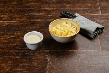 pasta with sauce on wooden background