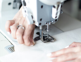 female hands at work with sewing machine