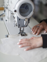female hands at work with sewing machine