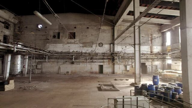 Aerial trucking shot of the interior of an abandoned factory