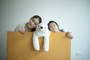 Fototapeta premium Happy family playing into new home. Mother and children having fun together.