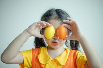 Happy woman smiling and holding colorful Easter eggs front eyes.