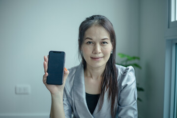 Naklejka premium Woman worship with smartphone at home. Church online concept.
